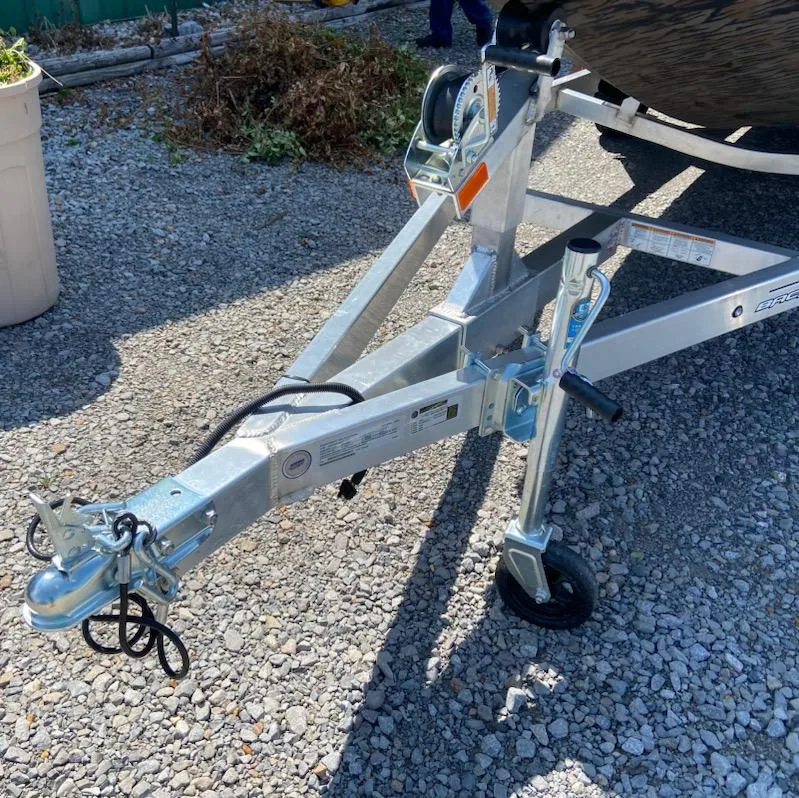 Slide: The Image of Trailer hitch of 2025 Xpress H16DB boat on gravel surface. - 4