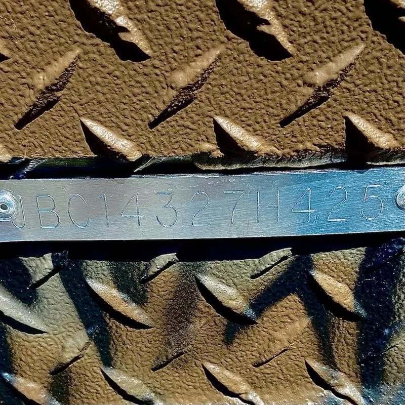 Slide: The Image of Close-up of a metal plate with embossed serial number on textured surface. - 5