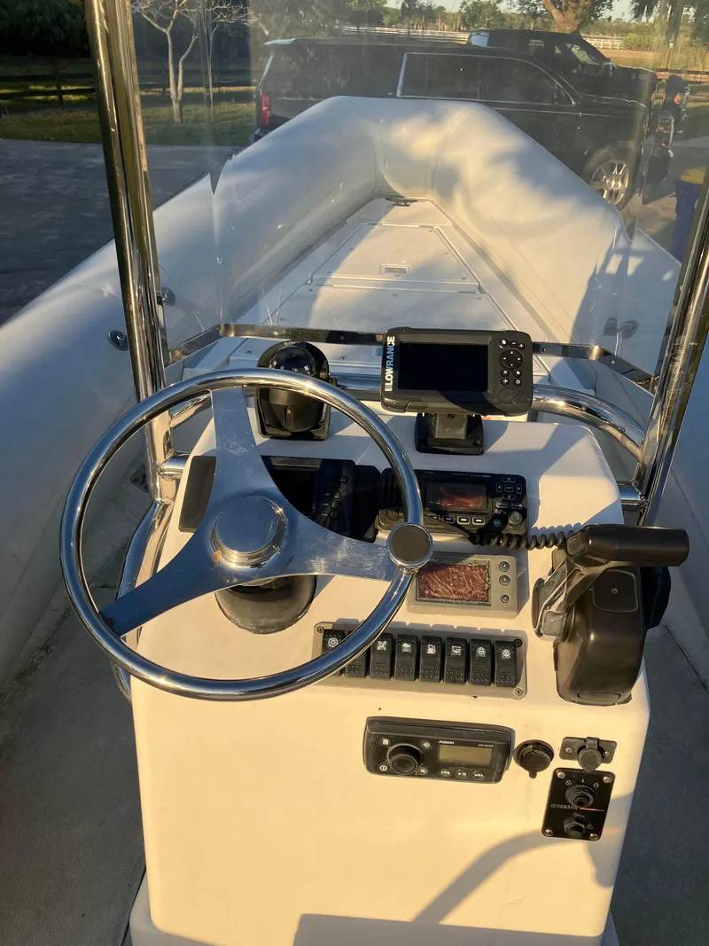 Slide: The Image of 2011 Novurania NE70 boat console with steering wheel and navigation equipment. - 3