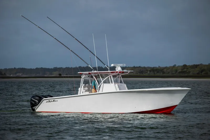 Slide: The Image of 2024 SeaHunter 35 Tournament boat on water, equipped with fishing rods. - 13