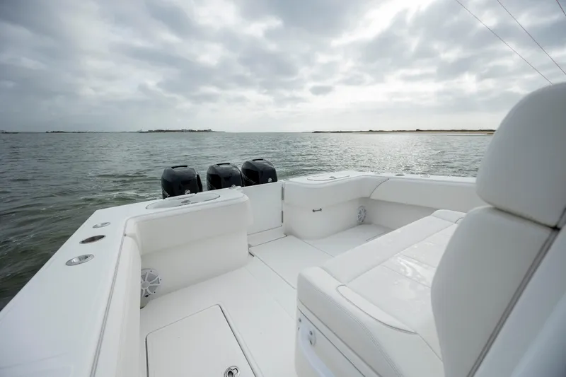 Slide: The Image of 2024 SeaHunter 35 Tournament boat on open water, showcasing spacious deck and seating. - 14