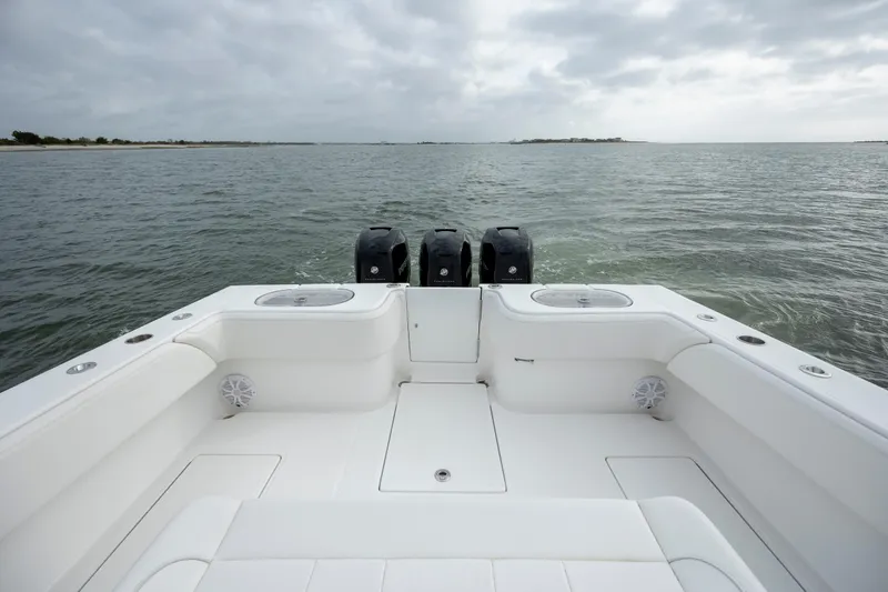 Slide: The Image of 2024 SeaHunter 35 Tournament boat on open water, featuring triple outboard engines. - 15
