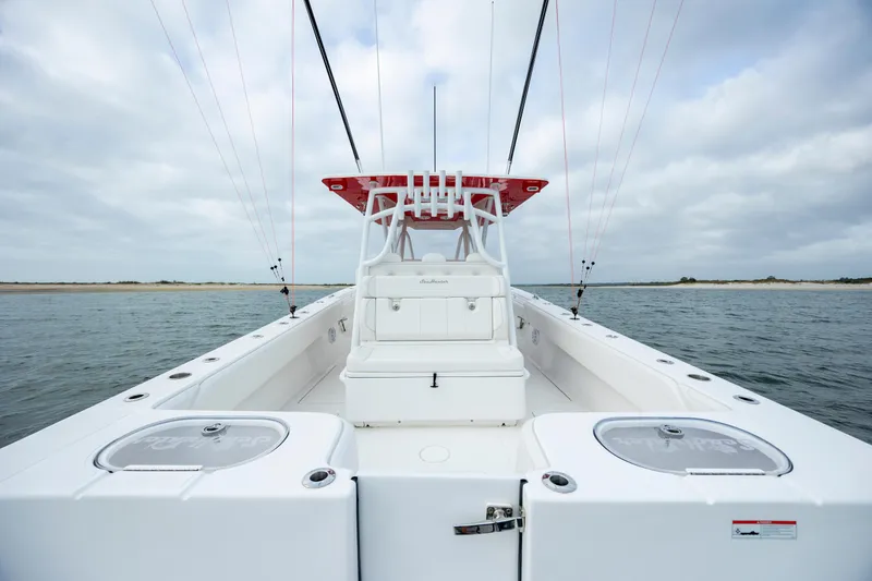 Slide: The Image of 2024 SeaHunter 35 Tournament boat on water, showcasing spacious deck and fishing amenities. - 19