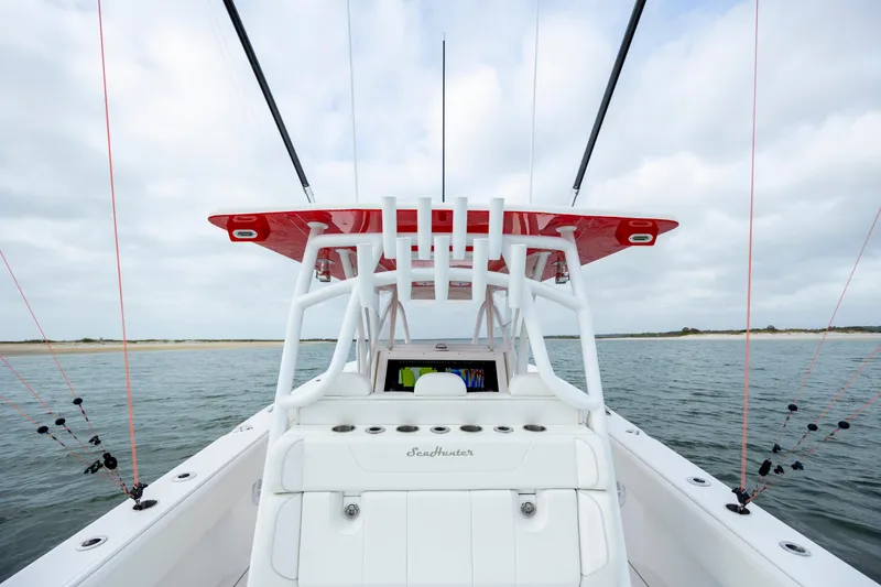 Slide: The Image of 2024 SeaHunter 35 Tournament boat on water, featuring fishing rods and red canopy. - 22