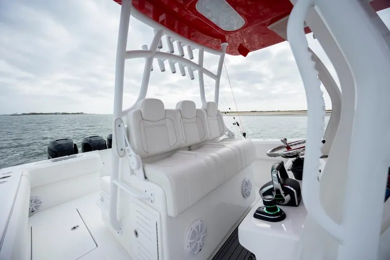 Slide: The Image of 2024 SeaHunter 35 Tournament boat interior with white seating and red canopy. - 28