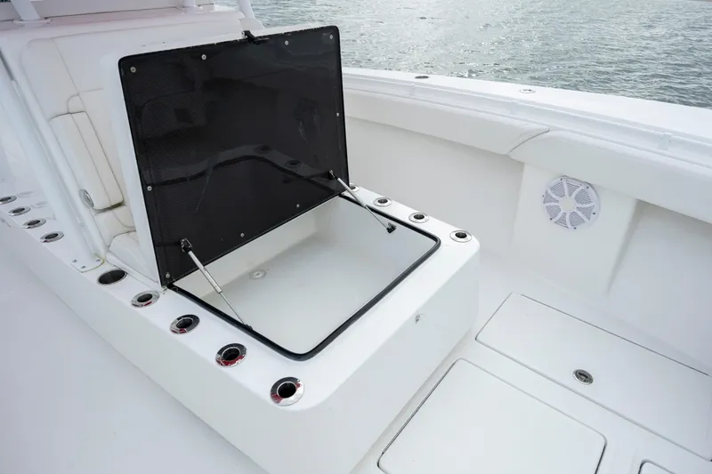 Slide: The Image of 2024 SeaHunter 35 Tournament boat with open storage compartment and rod holders. - 37