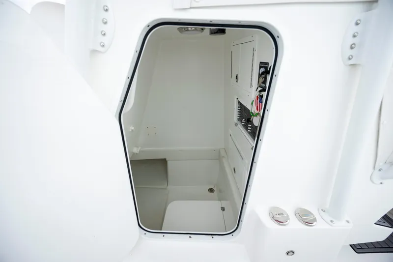 Slide: The Image of 2024 SeaHunter 35 Tournament boat interior compartment, featuring sleek white design and storage area. - 38