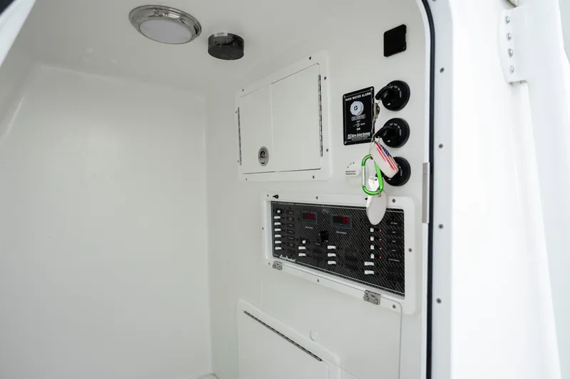 Slide: The Image of 2024 SeaHunter 35 Tournament interior control panel with switches and storage compartments. - 39