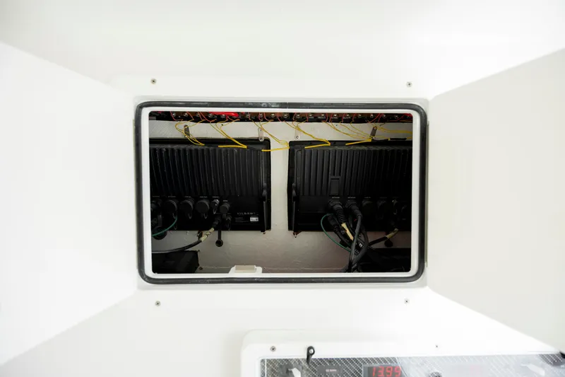 Slide: The Image of 2024 SeaHunter 35 Tournament boat electronics compartment with wiring and equipment. - 42