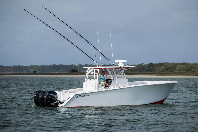 Slide: The Image of 2024 SeaHunter 35 Tournament boat on water, featuring dual outboard motors and fishing rods. - 48
