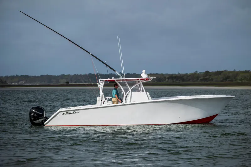 Slide: The Image of 2024 SeaHunter 35 Tournament boat on water, side view, with fishing rods. - 49