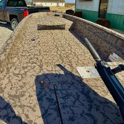 Slide: The Image of 2025 Xpress H16DB boat with Nat Gear Paint, parked near a truck. - 4