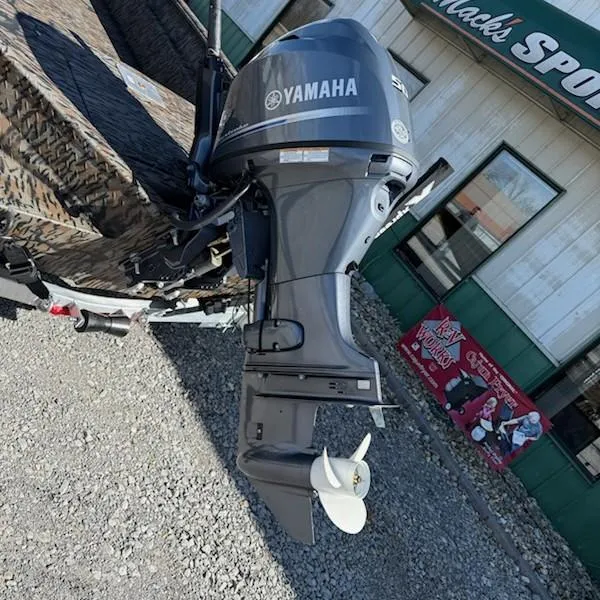 Slide: The Image of Outboard motor on Xpress H16DB boat, 2025 model, parked outside a sports shop. - 3