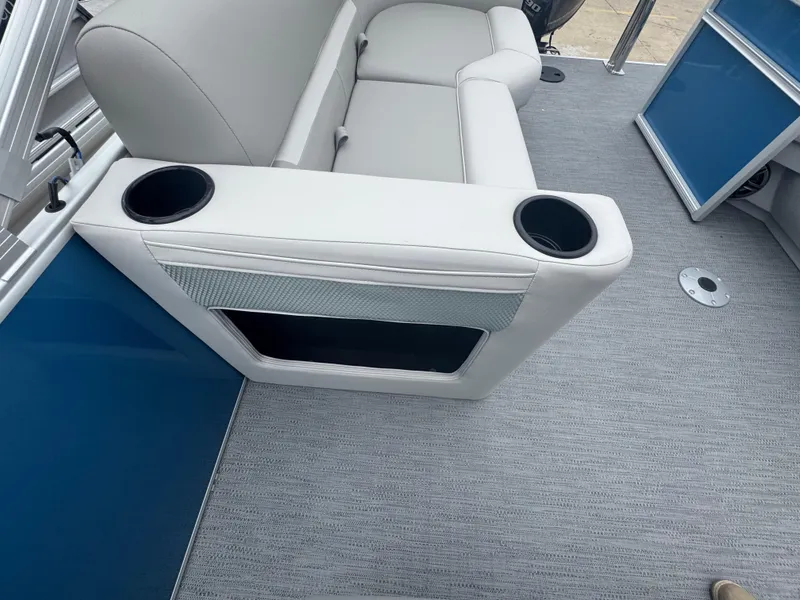 Slide: The Image of Luxurious seating on 2025 Godfrey EX2286SBX boat with cup holders and modern design. - 10