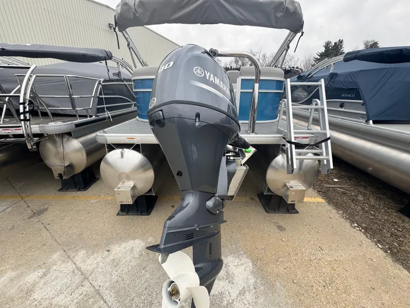 Slide: The Image of 2025 Godfrey EX2286SBX pontoon boat with Yamaha outboard motor, docked outdoors. - 12