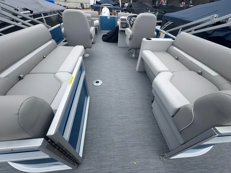 Slide: The Image of 2025 Godfrey EX2286SBX pontoon boat interior with gray seating and modern design. - 13
