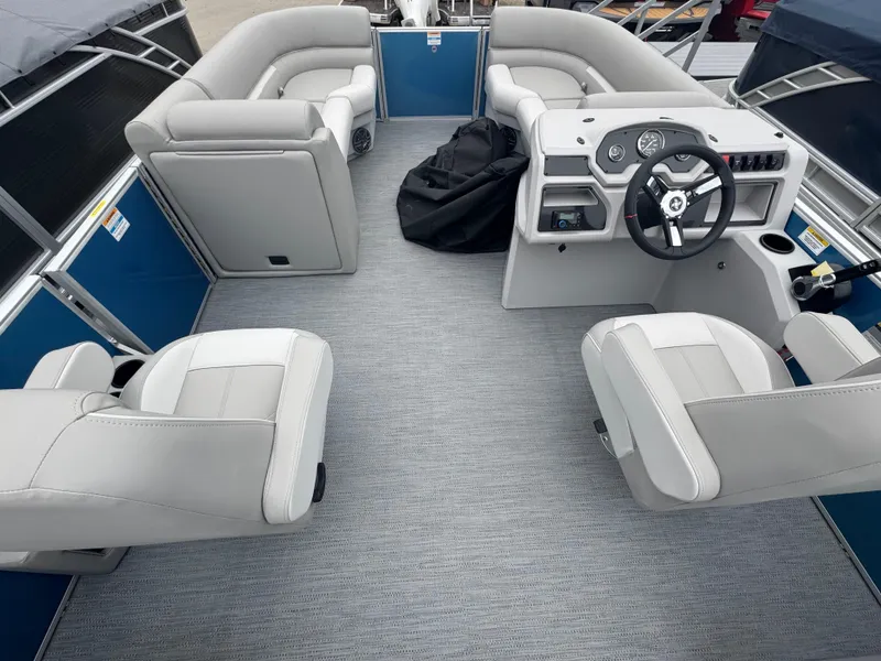 Slide: The Image of 2025 Godfrey EX2286SBX boat interior with modern seating and steering console. - 15