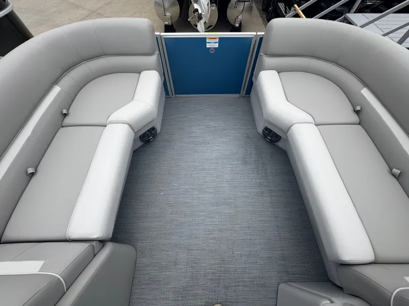 Slide: The Image of 2025 Godfrey EX2286SBX pontoon boat interior with gray seating and carpeted floor. - 18