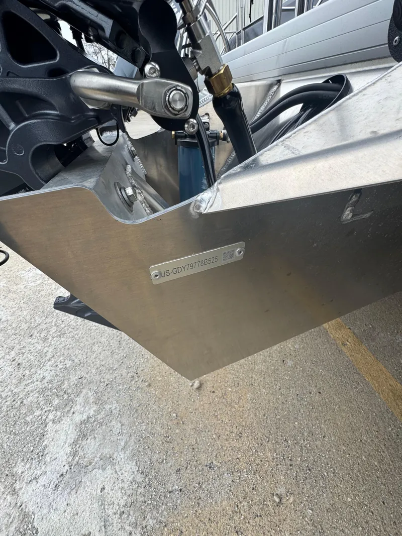Slide: The Image of Close-up of a 2025 Godfrey EX2286SBX boat hull with visible serial number plate. - 19