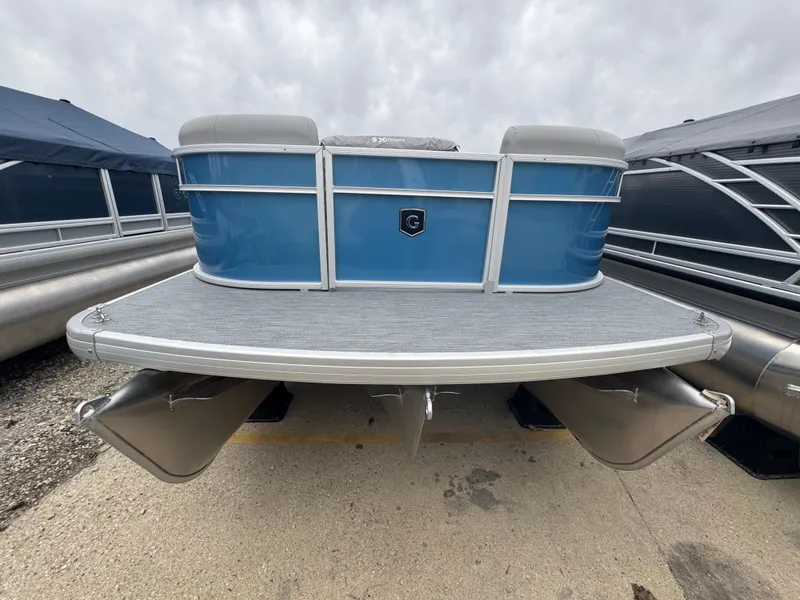 Slide: The Image of 2025 Godfrey EX2286SBX pontoon boat with blue exterior and silver pontoons. - 2
