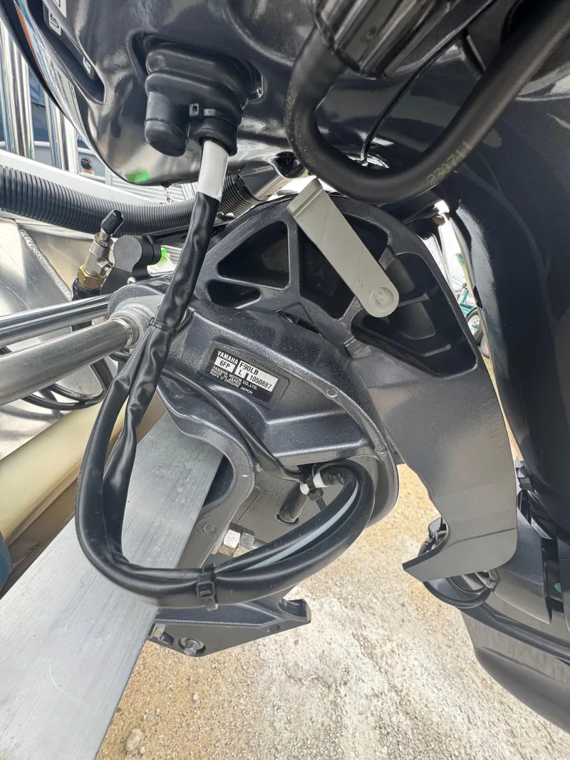 Slide: The Image of Close-up of a 2025 Godfrey EX2286SBX boat engine component with visible wiring and labels. - 20