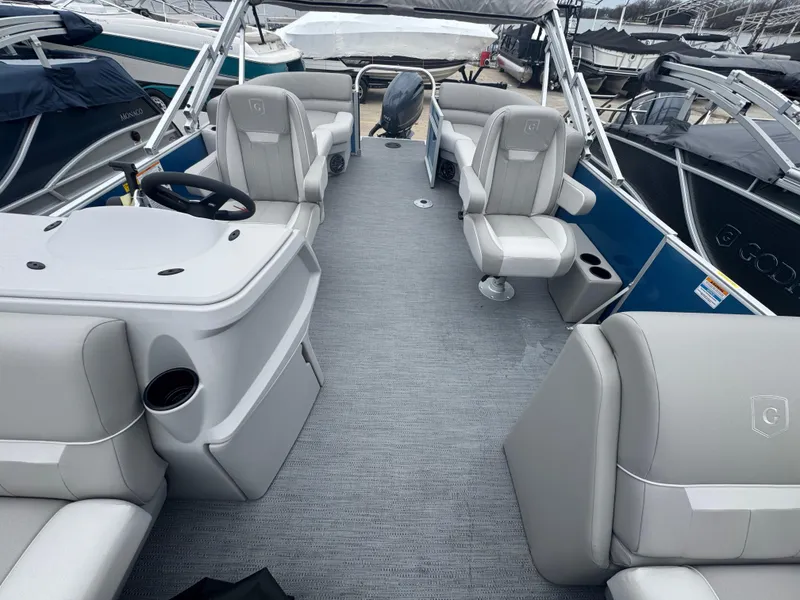 Slide: The Image of Interior of a 2025 Godfrey EX2286SBX boat with modern seating and steering console. - 3