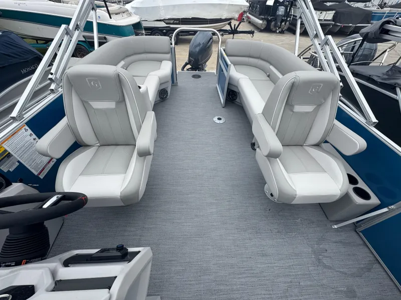 Slide: The Image of 2025 Godfrey EX2286SBX pontoon boat interior with plush seating and modern design. - 6
