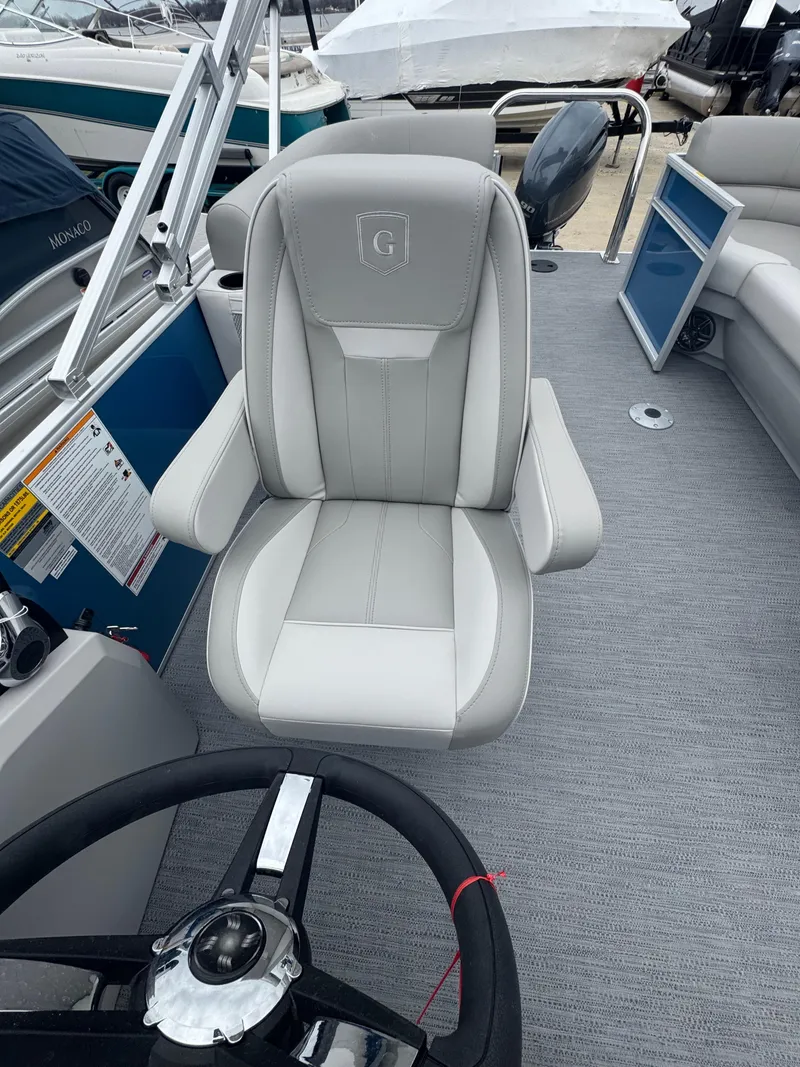 Slide: The Image of Captain's chair on 2025 Godfrey EX2286SBX boat, featuring sleek design and comfortable seating. - 7