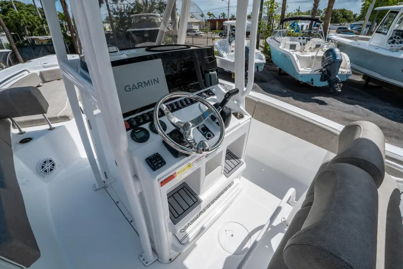 Slide: The Image of 2025 Sea Hunt Ultra 234 boat cockpit with Garmin navigation system. - 16