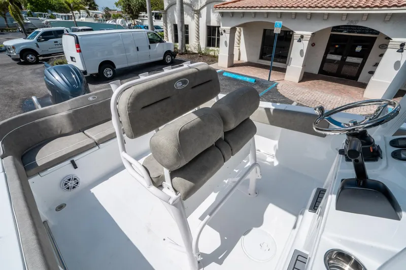 Slide: The Image of 2025 Sea Hunt Ultra 234 boat interior with seating and steering wheel. - 19