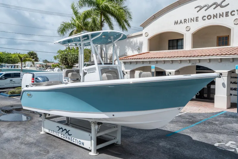 Slide: The Image of 2025 Sea Hunt Ultra 234 boat displayed at Marine Connection dealership. - 8