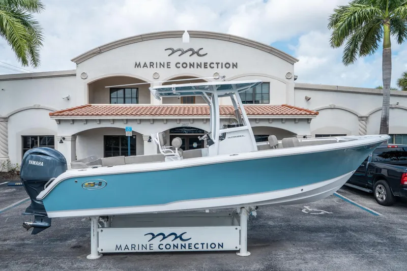 Slide: The Image of 2025 Sea Hunt Ultra 234 boat displayed at Marine Connection dealership. - 1