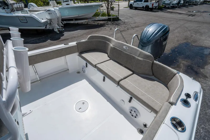 Slide: The Image of 2025 Sea Hunt Ultra 234 boat interior with cushioned seating and Yamaha engine. - 12