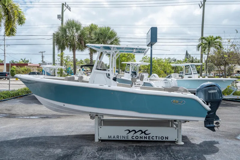 Slide: The Image of 2025 Sea Hunt Ultra 234 boat displayed at Marine Connection dealership. - 5