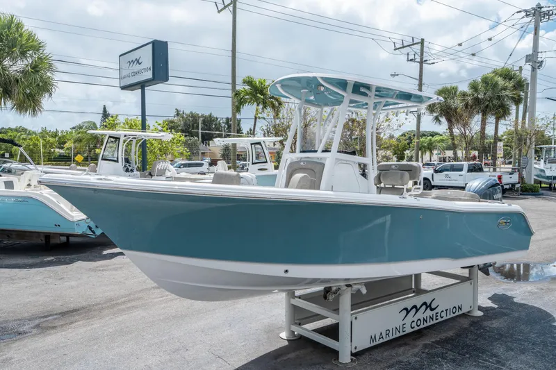 Slide: The Image of 2025 Sea Hunt Ultra 234 boat displayed at Marine Connection dealership. - 6