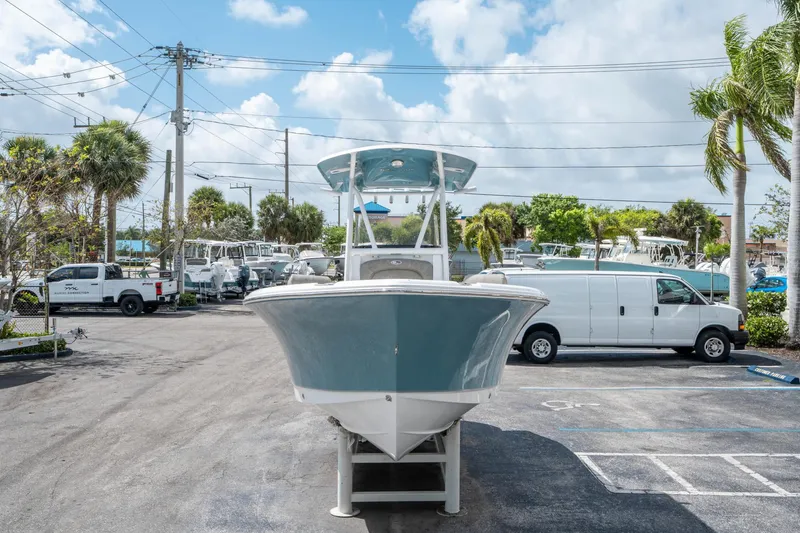 Slide: The Image of 2025 Sea Hunt Ultra 234 boat displayed in a parking lot with palm trees. - 7