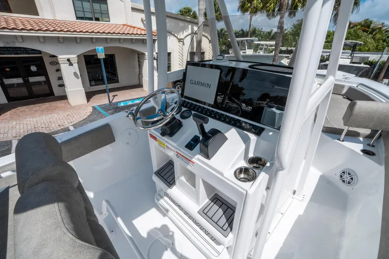 Slide: The Image of 2025 Sea Hunt Ultra 234 boat console with Garmin navigation system and steering wheel. - 17
