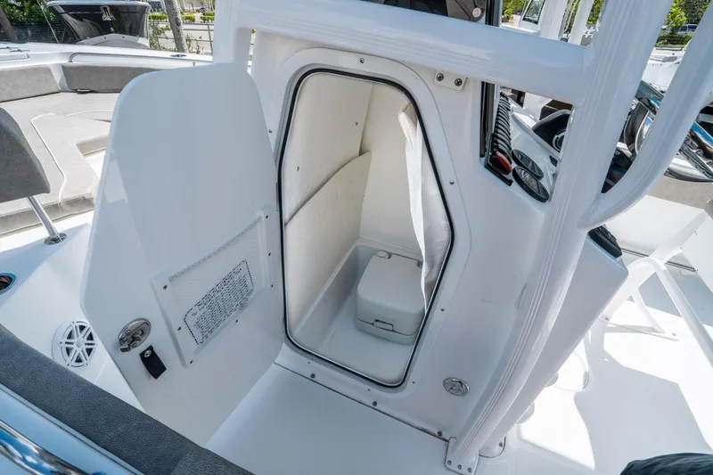 Slide: The Image of 2025 Sea Hunt Ultra 234 boat interior with open storage compartment. - 20