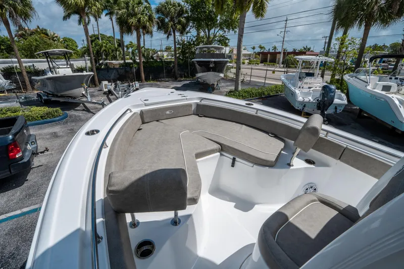 Slide: The Image of 2025 Sea Hunt Ultra 234 boat with spacious seating, parked outdoors. - 21