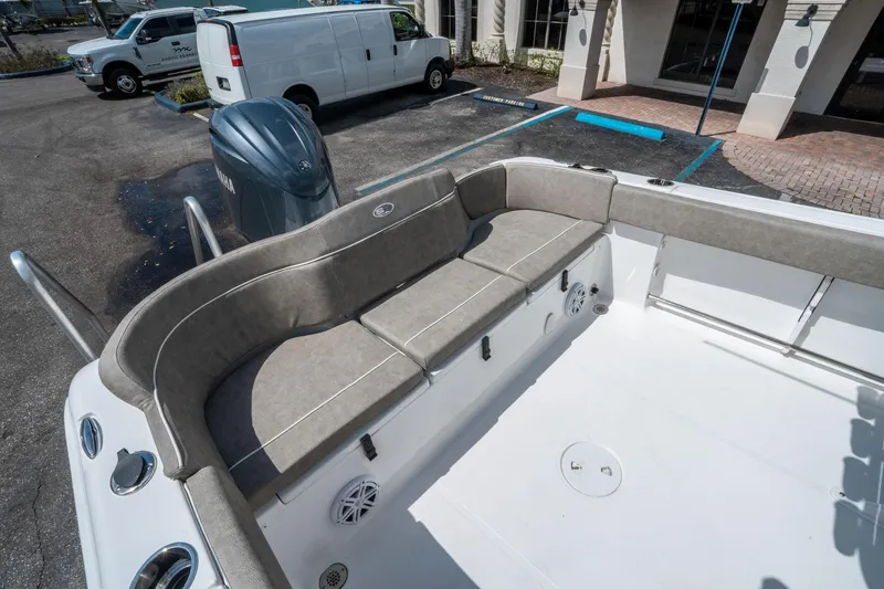 Slide: The Image of 2025 Sea Hunt Ultra 234 boat interior with cushioned seating and Yamaha engine. - 11