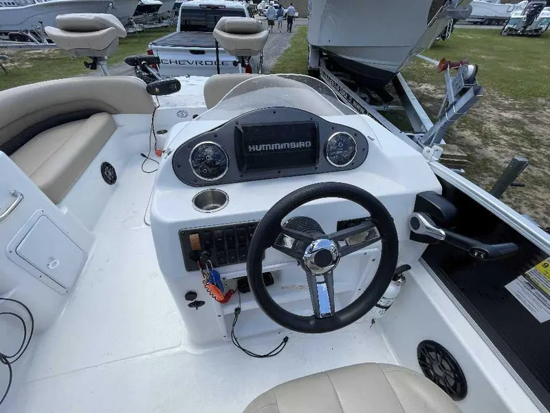 Slide: The Image of 2023 Hurricane Fundeck 198 Fish Package boat interior with steering wheel and control panel. - 1