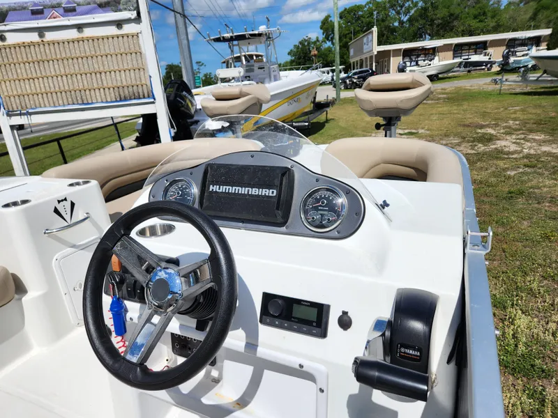 Slide: The Image of 2023 Hurricane Fundeck 198 Fish Package boat dashboard with steering wheel and controls. - 10