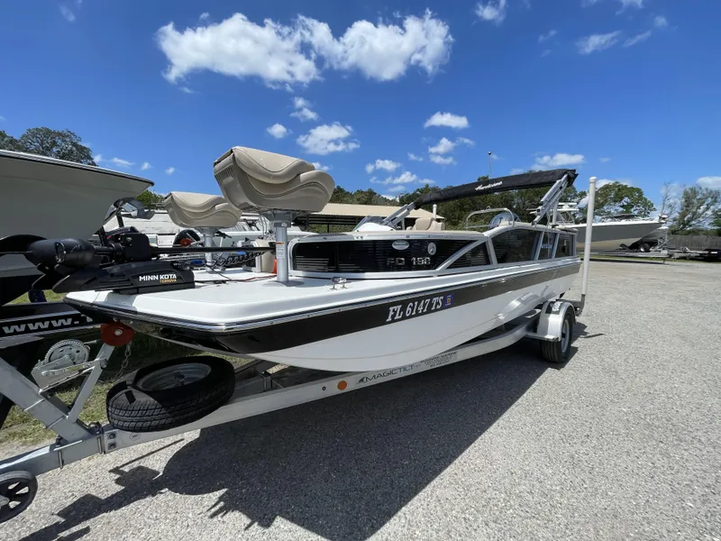Slide: The Image of 2023 Hurricane Fundeck 198 Fish Package boat on trailer under blue sky. - 15