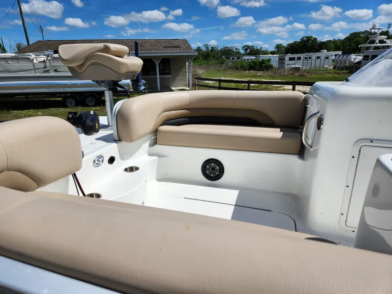 Slide: The Image of 2023 Hurricane Fundeck 198 Fish Package with beige seating, outdoor setting, and blue sky. - 7