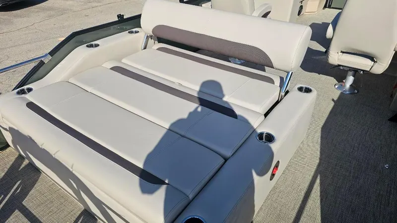 Slide: The Image of 2025 Bentley Pontoons Legacy 243 Swingback interior with plush seating and cup holders. - 8