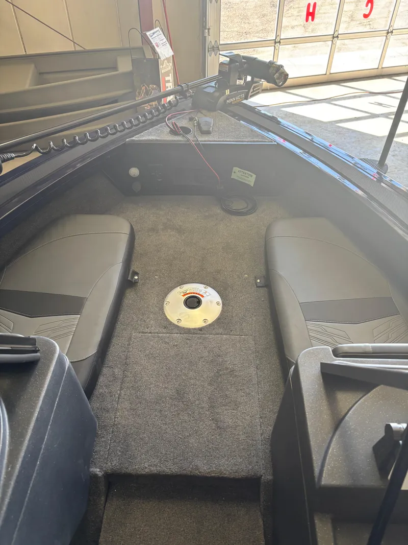 Slide: The Image of 2025 Tracker Targa V-18 Combo boat interior with seating and carpeted floor. - 13