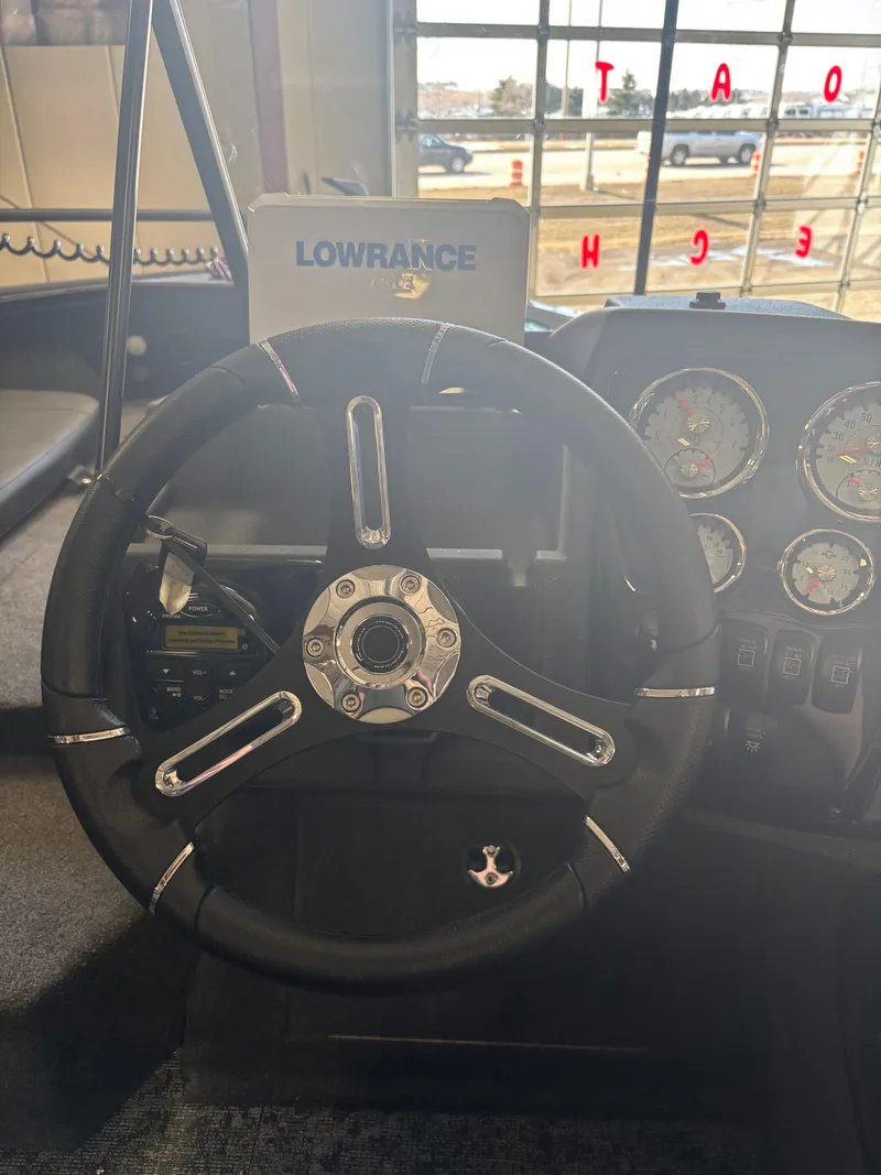 Slide: The Image of Steering wheel and dashboard of 2025 Tracker Targa V-18 Combo boat. - 15