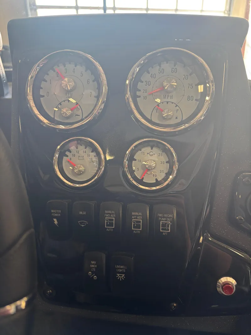 Slide: The Image of Dashboard of 2025 Tracker Targa V-18 Combo with gauges and control switches. - 16