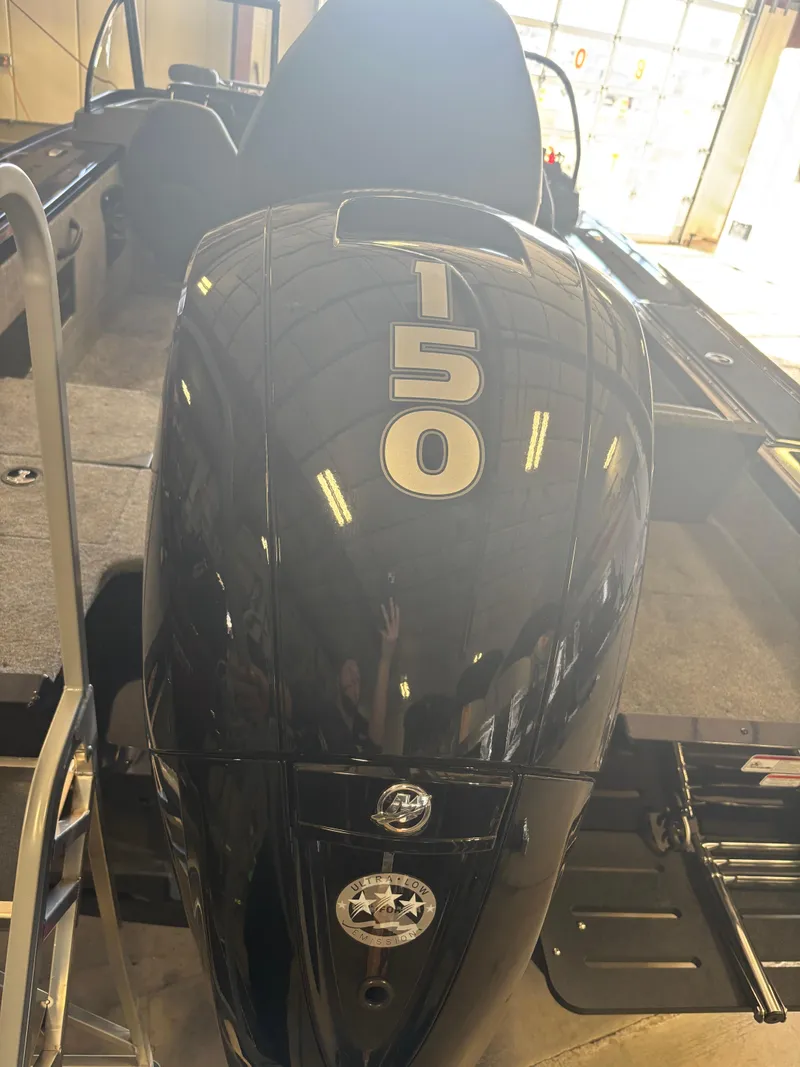 Slide: The Image of 2025 Tracker Targa V-18 Combo boat with 150 HP engine in showroom. - 2