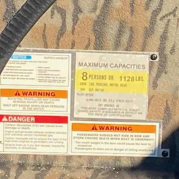 Slide: The Image of 2024 Xpress XP200 capacity and safety warning labels, maximum 8 persons or 1128 lbs. - 13